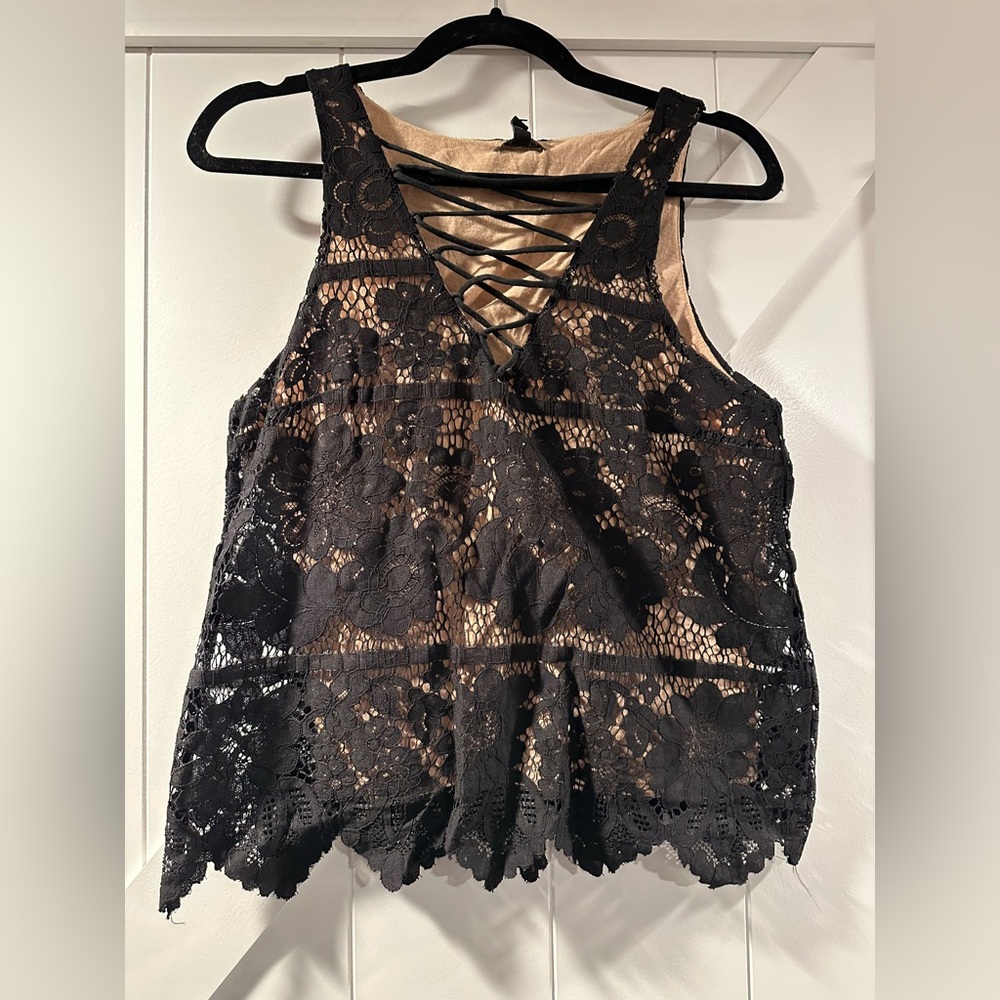 Lacey black tank top. Cross tie in front. Tags attached. Never worn